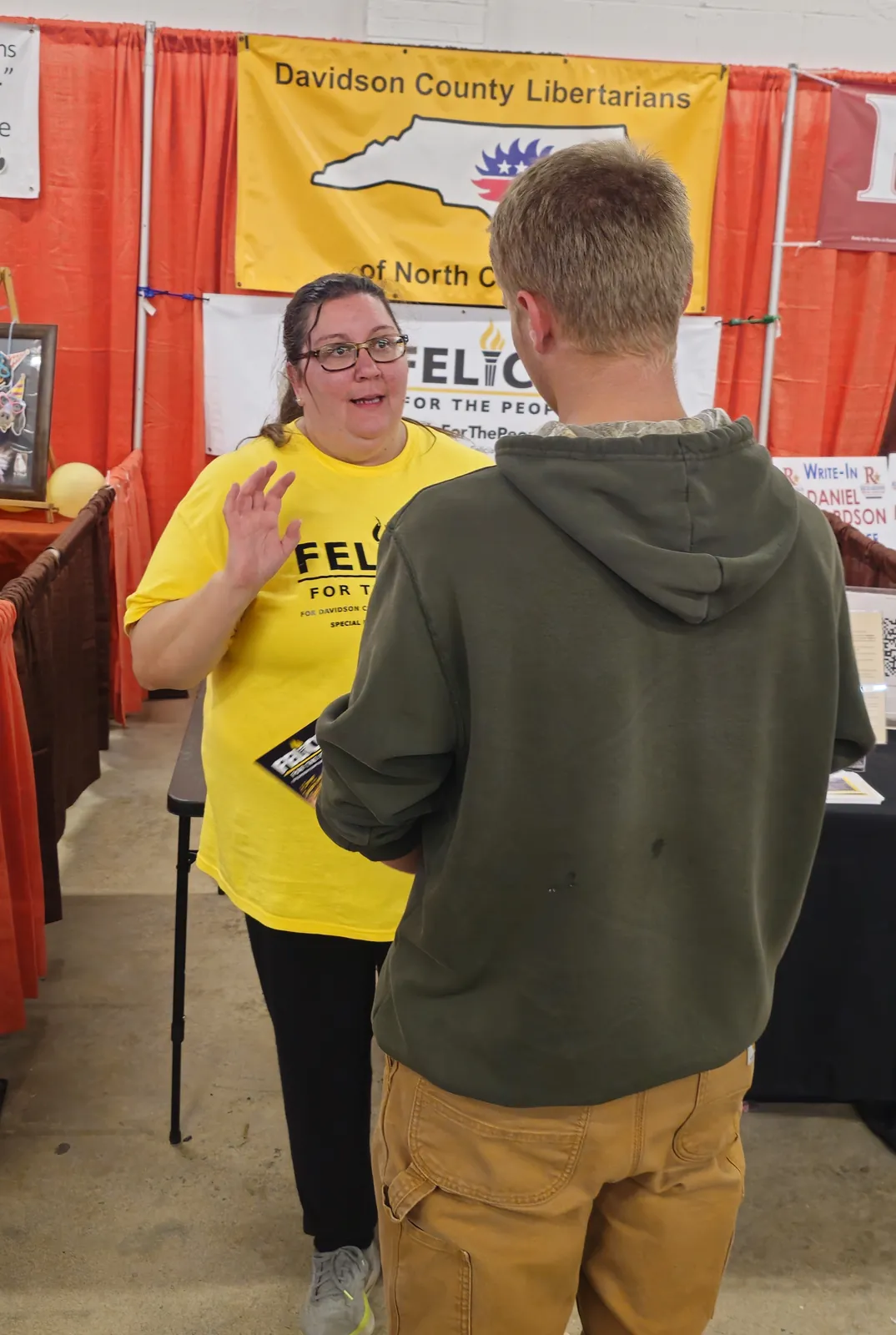 Felicia Dreher explaining her campaign to a Davidson County voter at the booth